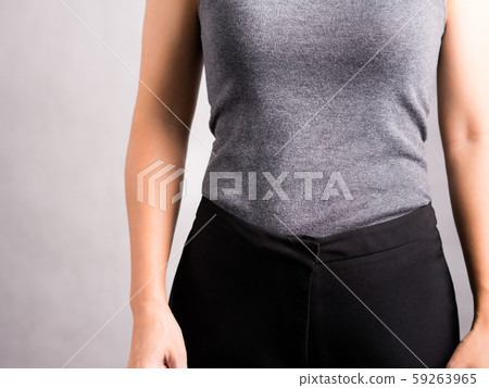 Studio closeup of a healthy, flat stomach and firm waist - woman body. Wellbeing, Abdominal muscle, Weight loss, Exercise training, Keto, Digestion, Woman health and diet concept. Studio closeup of a healthy, flat stomach and firm waist - woman body. Wellbeing, Abdominal muscle, Weight loss, Exercise training, Keto, Digestion, Woman health and diet concept. 59263965