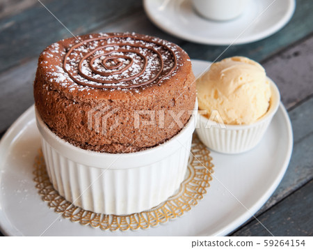 Chocolate Souffle with vanilla ice cream on white plate 59264154