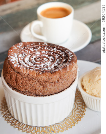 Chocolate Souffle with vanilla ice cream on white plate 59264155