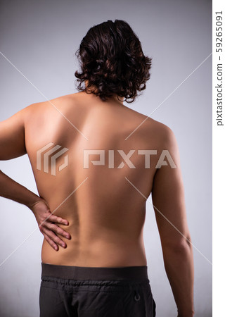 Man suffering from backbain on gray 59265091