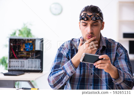 Young handsome technician repairing mobile phone Young handsome technician repairing mobile phone 59265131