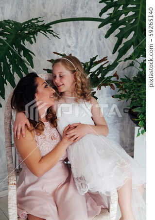 Portrait of a beautiful fashionable mom and daughter's family love Portrait of a beautiful fashionable mom and daughter's family love 59265140