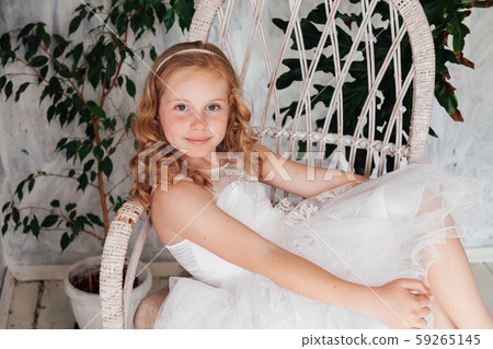 Beautiful fashionable girl 10 years old in a white dress Beautiful fashionable girl 10 years old in a white dress 59265145