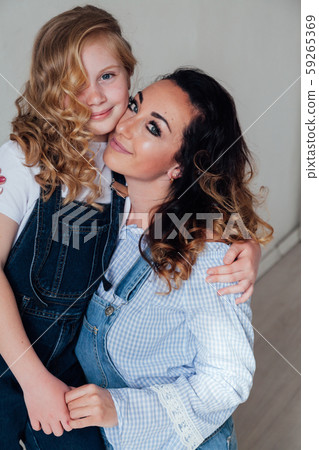 Portrait of a beautiful fashionable mom and daughter's family love Portrait of a beautiful fashionable mom and daughter's family love 59265369