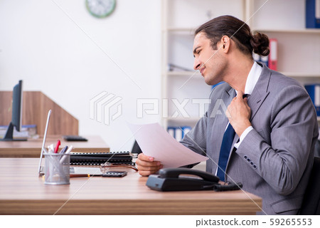 Unhappy male businessman in the office Unhappy male businessman in the office 59265553