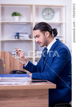Young handsome businessman working in the office 59265653