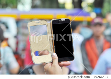 Close up Hand hold mobile phone with broken glass 59266597