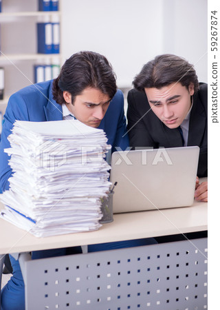 Two male colleagues unhappy with excessive work 59267874