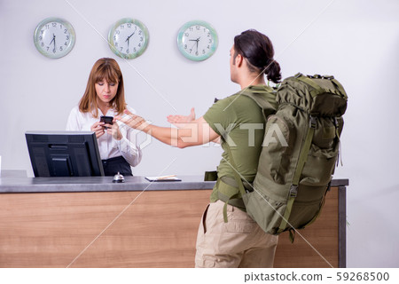 Young man at the hotel reception 59268500