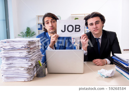 Two male colleagues unhappy with excessive work 59268584