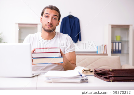 Young male student preparing for exams at home Young male student preparing for exams at home 59270252