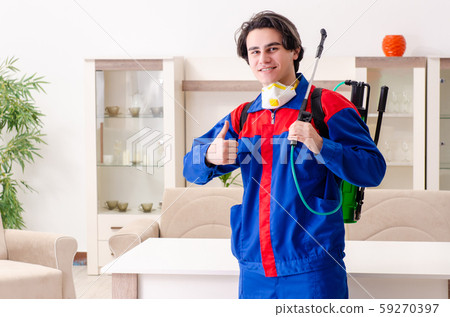 Young contractor doing pest control at home 59270397