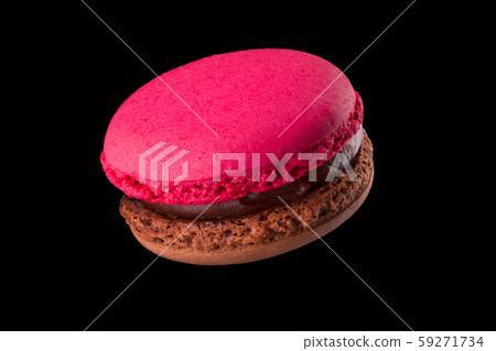 Macro photo of french chocolate macaroon or macaron isolated on black background 59271734