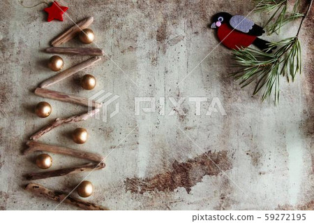 Christmas tree made of wooden branches and bullfinch on a pine branch 59272195