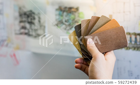 Male architect hand holding wooden color swatch 59272439