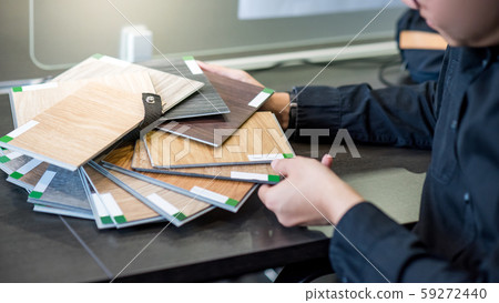 Asian architect man choosing wooden color swatch 59272440