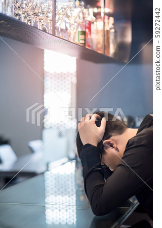 Asian Businessman feeling hangover at the bar Asian Businessman feeling hangover at the bar 59272442