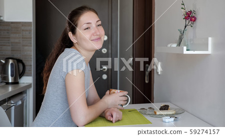 Young woman traveler is having a breakfast in hotel room. Young woman traveler is having a breakfast in hotel room. 59274157