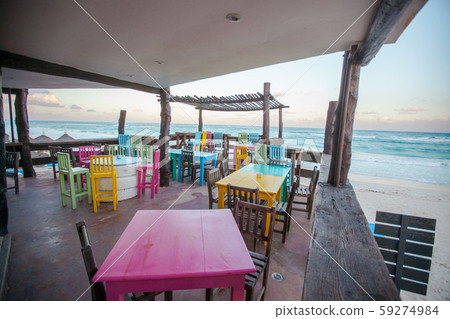 Bright colored bar-restaurant on the white sandy beach in Tulum Bright colored bar-restaurant on the white sandy beach in Tulum 59274984