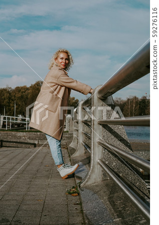 Stylish Pretty Woman in Autumn Fashion walking in the city Stylish Pretty Woman in Autumn Fashion walking in the city 59276116