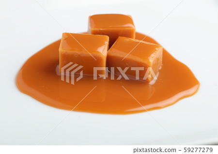 Fudge blocks under caramel sauce 59277279