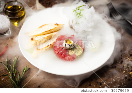 Tuna tartare served on a plate in restaurant 59279659