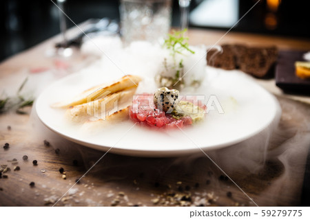 Tuna tartare served on a plate in restaurant 59279775