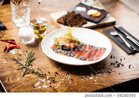 Tuna sashimi served on a plate in restaurant 59280385