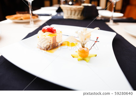 Sea buckthorn cheese cake served on a plate Sea buckthorn cheese cake served on a plate 59280640