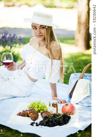 Portrait of happy young woman having rest on picnic in park Portrait of happy young woman having rest on picnic in park 59280642