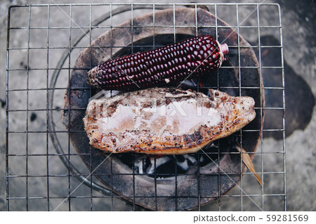 Beef and corn grilled on a charcoal stove. Barbecue hamburger. 59281569