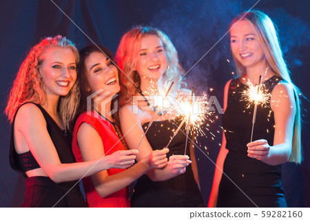 Birthday party, new year and holidays concept - Group of female friends celebrating holding 59282160