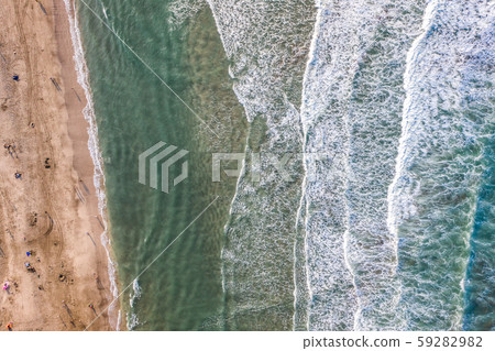 Aerial view of sandy beach with tourists swimming 59282982