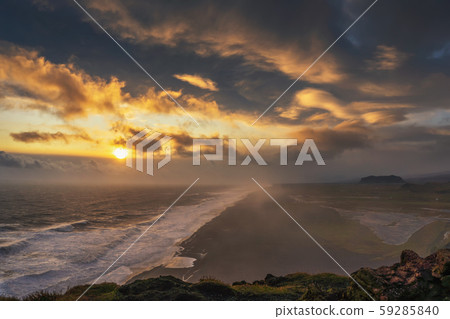 Dramatic sunset above a black beach viewed from Dyrholaey viewpoint in Iceland Dramatic sunset above a black beach viewed from Dyrholaey viewpoint in Iceland 59285840