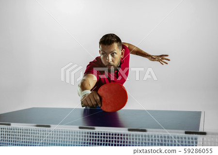 Young man playing table tennis on white studio background 59286055