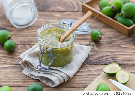 Fresh feijoa jam in a glass jar on the wooden Fresh feijoa jam in a glass jar on the wooden 59286752