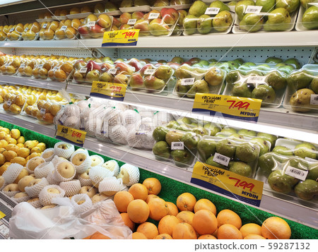 Fruits packed inside plastic container and plastic wrap. Displayed for sale on the cool chiller rack inside the huge supermarket.  59287132
