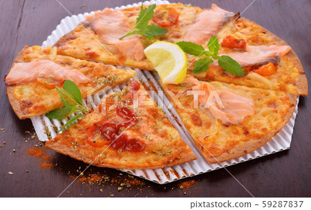 Pizza smoked salmon and lemon on wooden background Pizza smoked salmon and lemon on wooden background 59287837