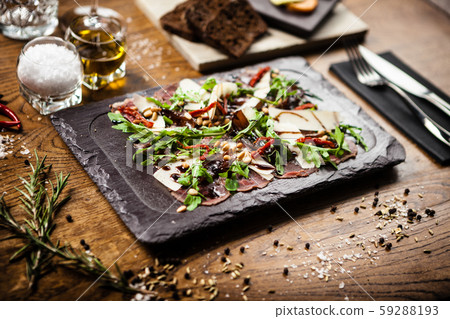 Beef carpaccio served on a board in restaurant Beef carpaccio served on a board in restaurant 59288193