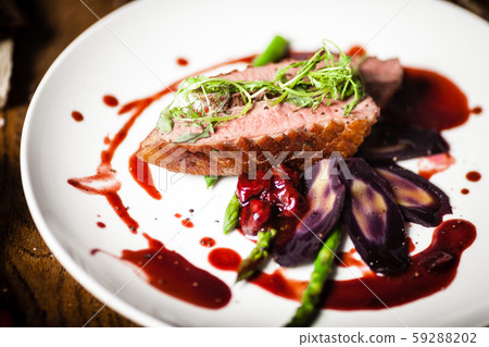 Duck breast served on a plate in restaurant Duck breast served on a plate in restaurant 59288202