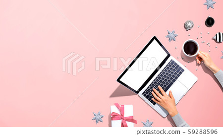 Christmas ornaments with person using a laptop computer 59288596