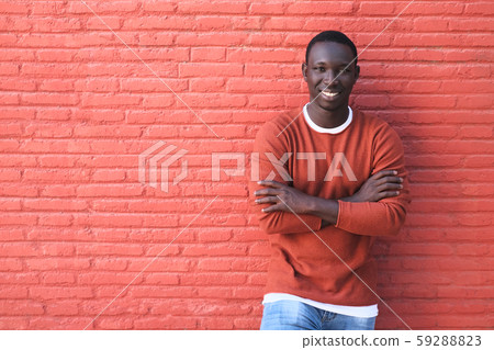 African Young Man Smiling With Red Wall In Background African Young Man Smiling With Red Wall In Background 59288823