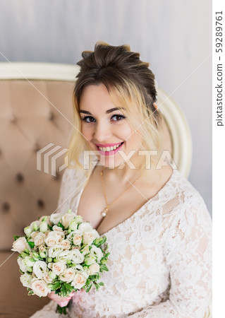 Beautiful woman in wedding dress in photo studio. Beautiful woman in wedding dress in photo studio. 59289761