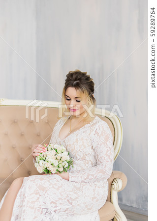 Beautiful woman in wedding dress in photo studio. Beautiful woman in wedding dress in photo studio. 59289764