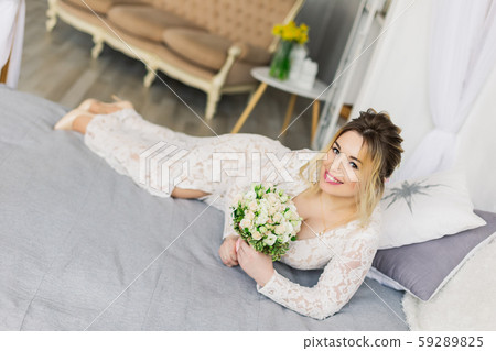 Beautiful woman in wedding dress in photo studio. 59289825