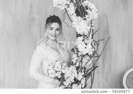 Beautiful woman in wedding dress in photo studio. 59289877