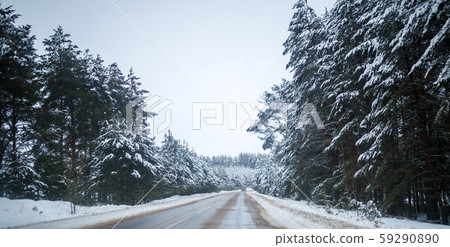 Photo of winter road with trees in snow 59290890