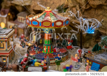 Amusement park in miniature with carousels in winter Amusement park in miniature with carousels in winter 59293231