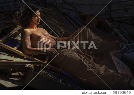 Fashion concept portrait of mechanic man take off a shirt showing muscle in the old garage Fashion concept portrait of mechanic man take off a shirt showing muscle in the old garage 59293649