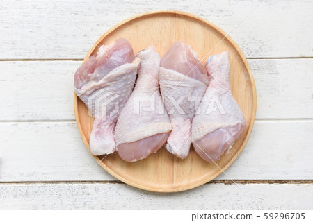 Raw chicken legs on wooden plate / fresh uncooked Raw chicken legs on wooden plate / fresh uncooked 59296705